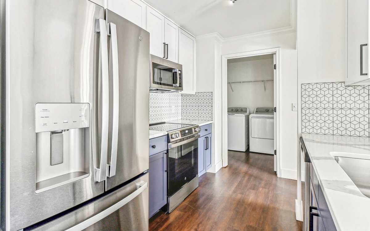 Fridge, oven and cabinets in the kitchen at Cypress in McKinney, Texas