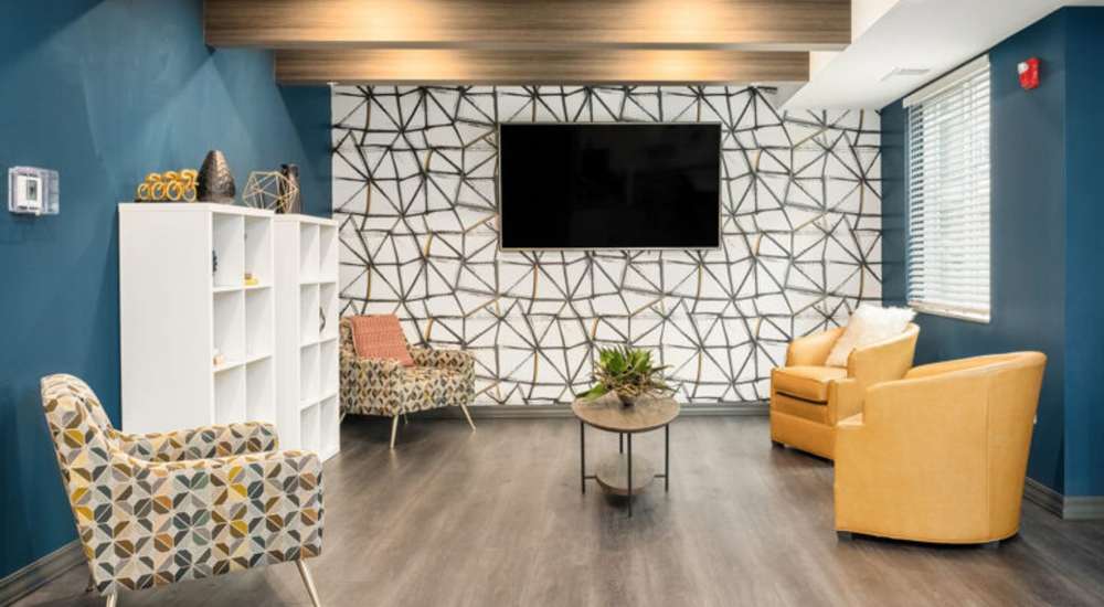 Clubhouse lounge living area with sofa at WaterWalk Raleigh - RTP in Morrisville, North Carolina