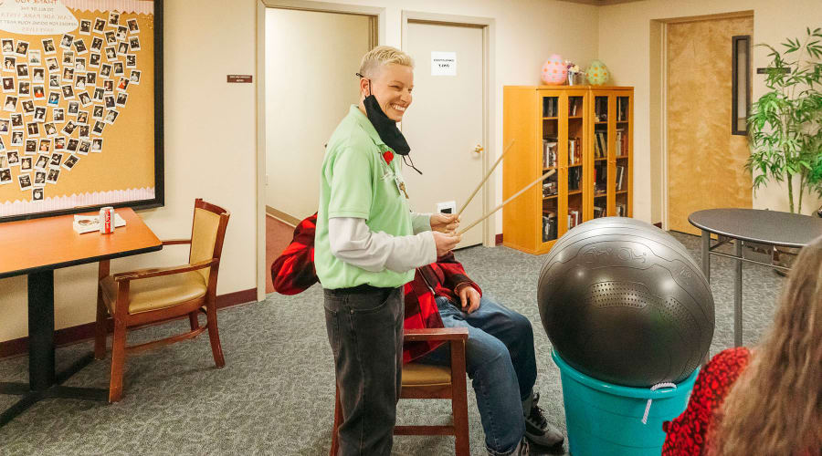 Activity instructor smiling while addressing the group at Cascade Park Vista Assisted Living in Tacoma, Washington