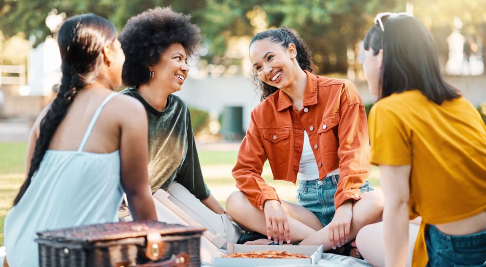 Friends having a picnic near Riverstone Apartments in Sacramento, California