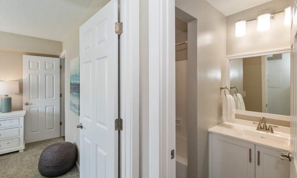 Ensuite bathroom with modern white cabinets and upgraded lighting