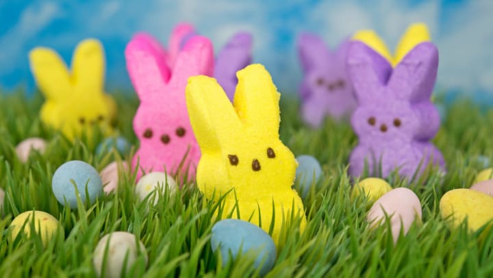 Colorful Easter bunny candy with eggs in green grass