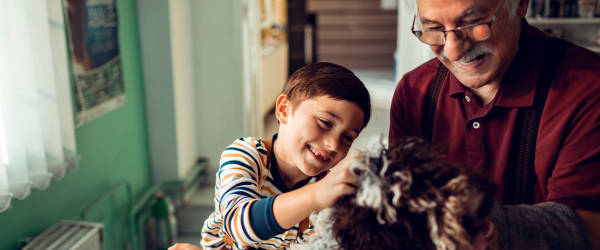 Resident and their grandson petting a dog at Lake Forest at Swift Creek in Midlothian, Virginia