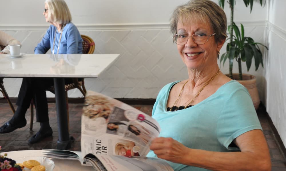 Senior lady ready a magazine at Regency Park Oak Knoll in Pasadena, California