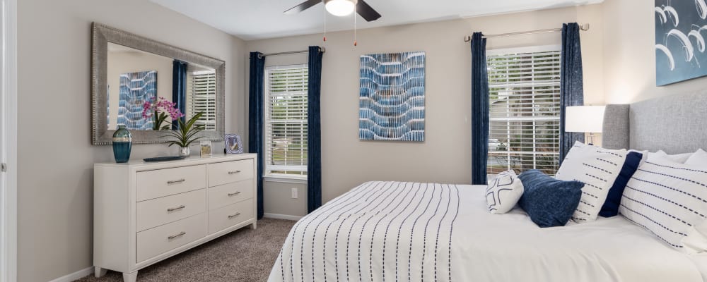 An apartment bedroom with a door to the patio at Lenox Gates in Mobile, Alabama 
