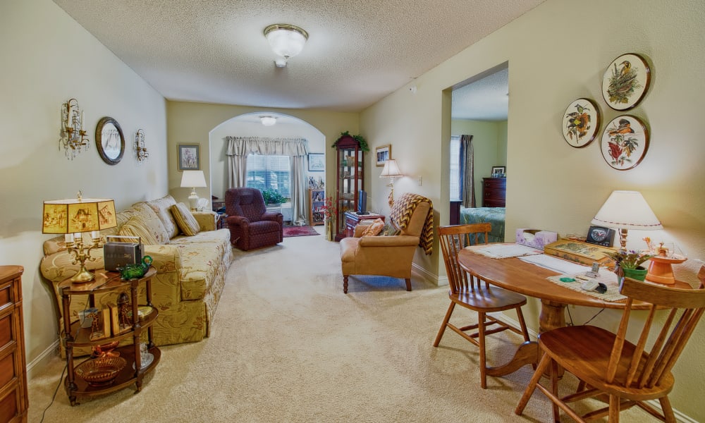 A decorated apartment dining room and living room at The Keystones of Cedar Rapids in Cedar Rapids, Iowa