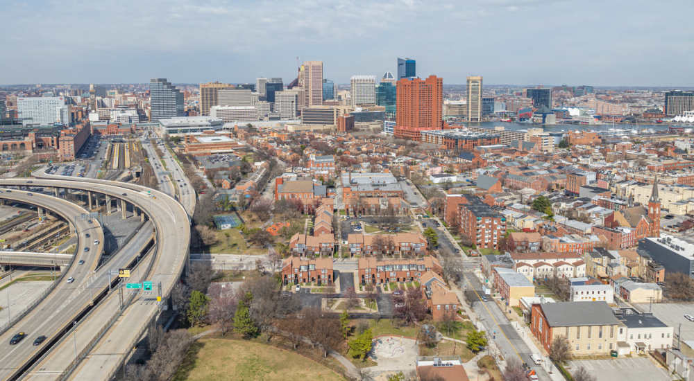 Aerial view of city skyline and highway at Sharp Leadenhall Apartments in Baltimore, Maryland