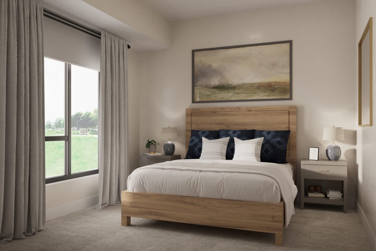 Bedroom furnished with bed, nightstands, and draped windows in a model senior apartment at Amira Bloomington in Bloomington, Minnesota