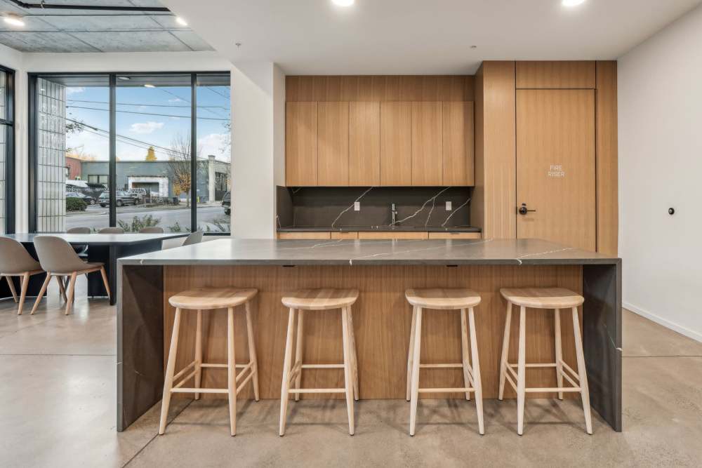 Lobby lounge with workspaces and kitchenette at Rothko Residences in Portland, Oregon