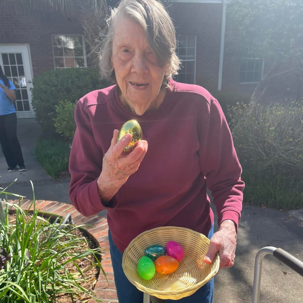 A resident with an easter egg at Lavender Hills Front Royal Campus in Front Royal, Virginia