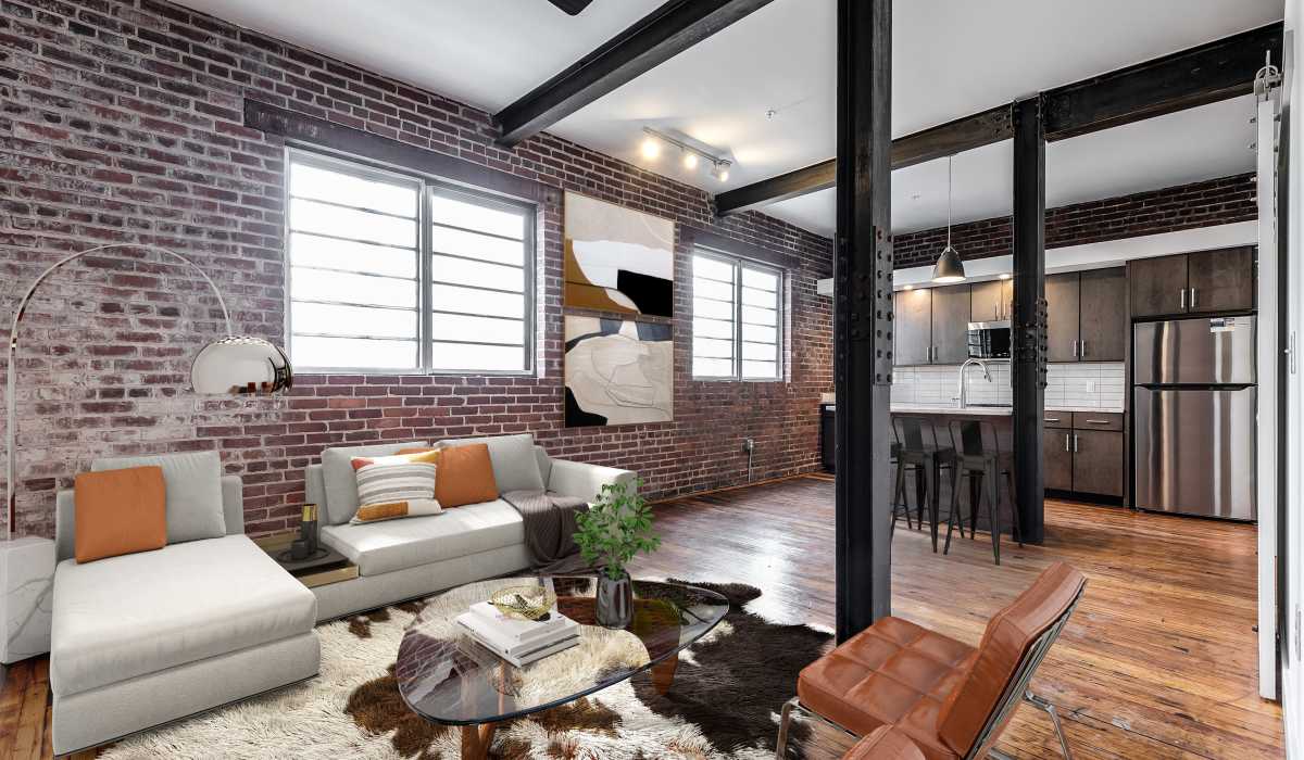 An apartment living room and kitchen at Landmark at Marshall Broad in Richmond, Virginia