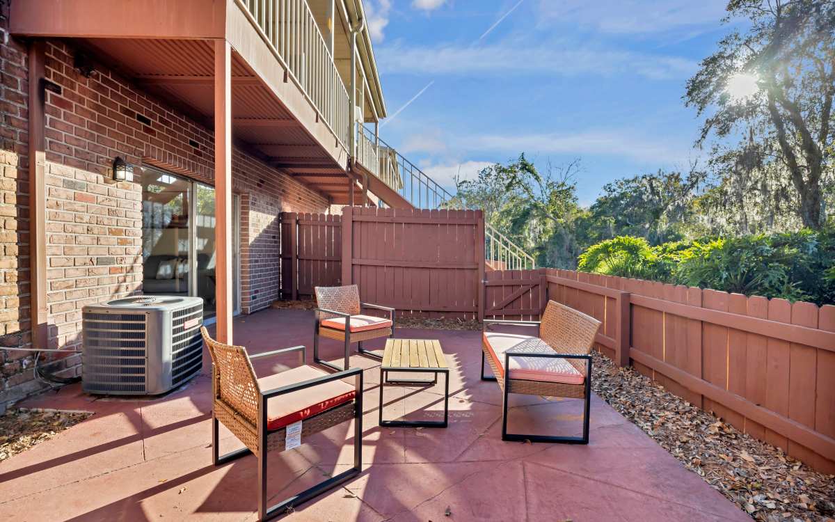 Patio area with seating spaces at Carlton Arms Of South Lakeland in Lakeland, Florida