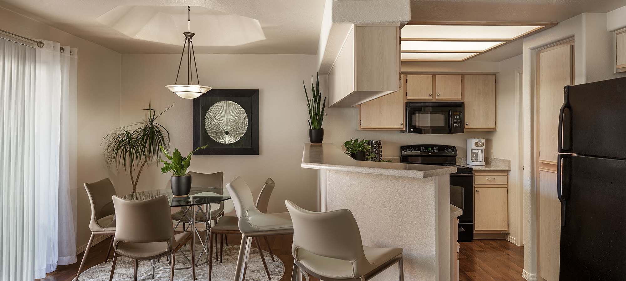 Partial view of a model home's kitchen from the dining area at San Palmilla in Tempe, Arizona