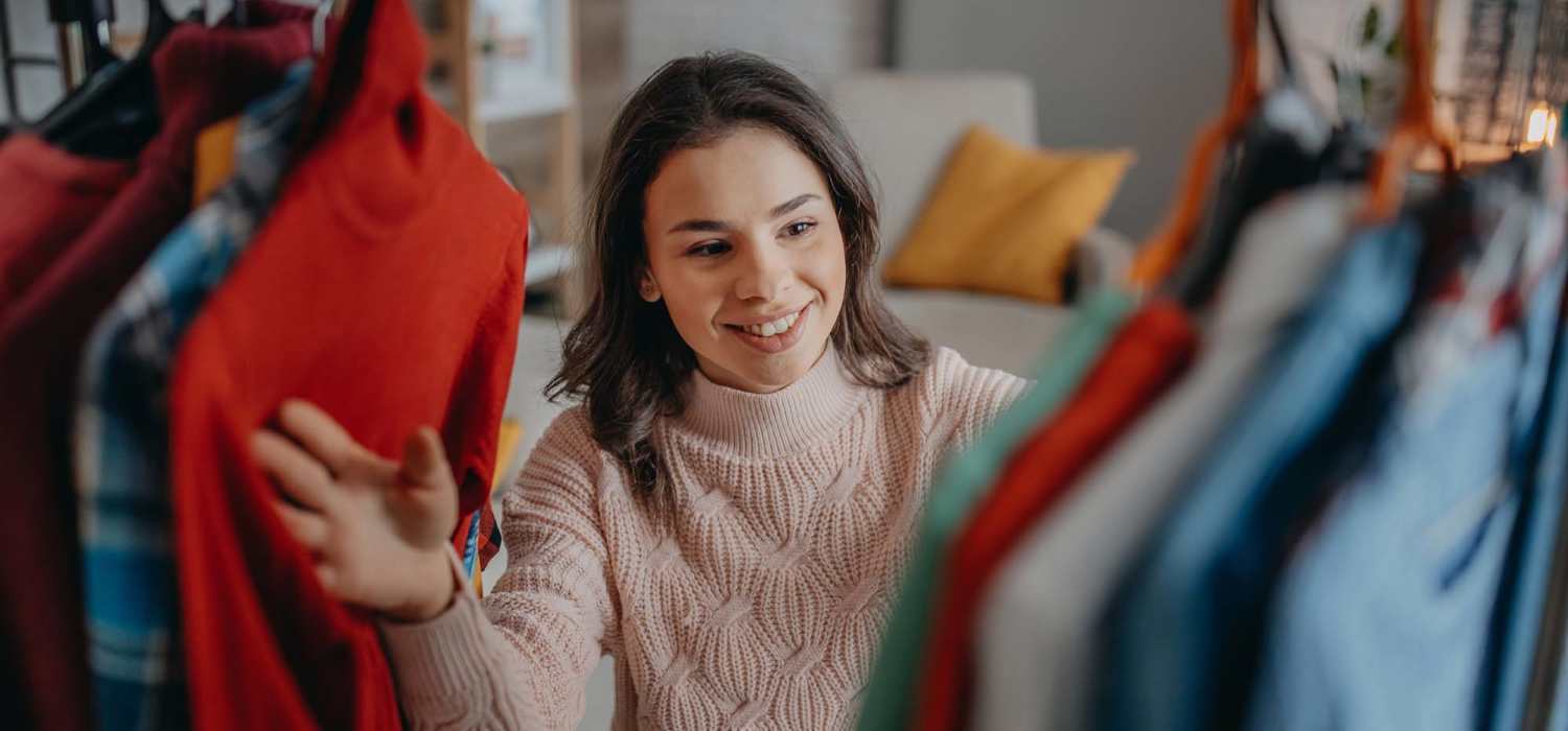 Resident woman in her walk-in closet at Greenville Trace in Wilmington, North Carolina