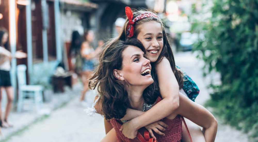 Resident giving her daughter a piggy-back ride near Hacienda Commons in Pleasanton, California