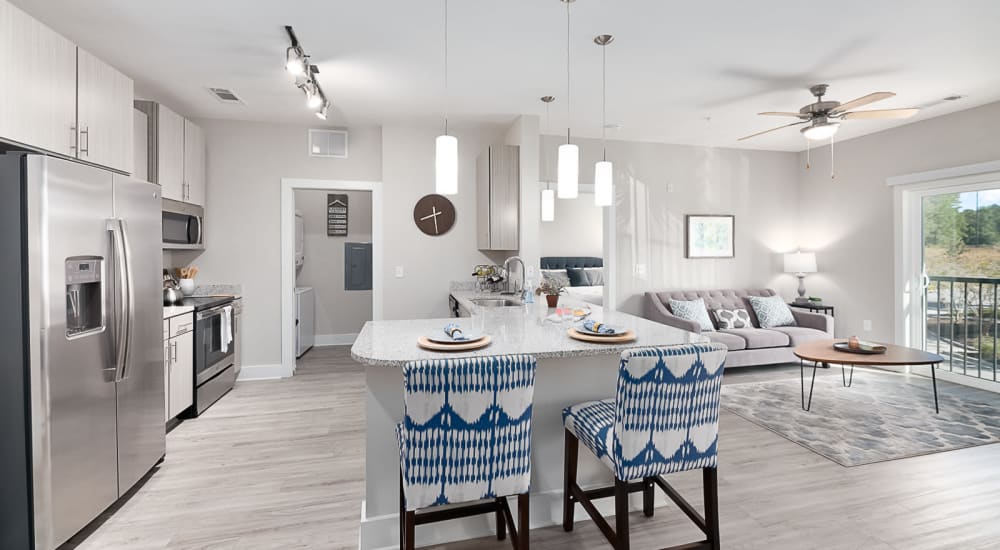 Bar seating in an apartment kitchen with an open floorplan at The Lively Indigo Run in Ladson, South Carolina