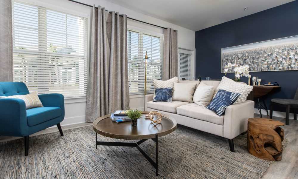 Living room with large window at South City Apartments in Summerville, South Carolina