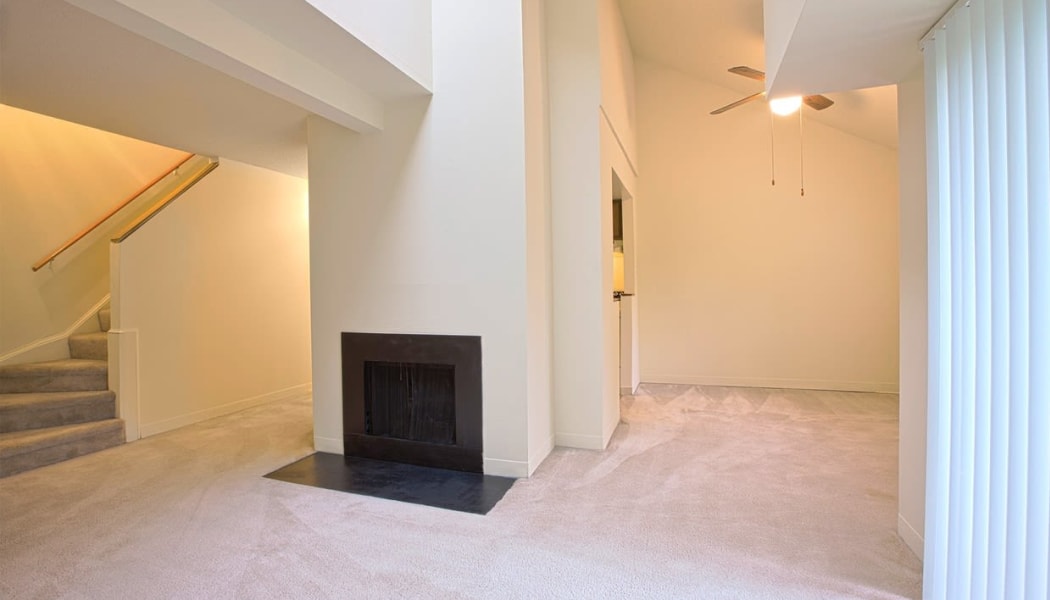 Fireplace and plush carpeting in a split-level home at The Chimneys of Cradlerock Apartments in Columbia, Maryland