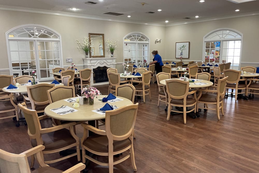 Multiple tables and sets of chairs in dining hall at Carriage Inn Conroe in Conroe, Texas
