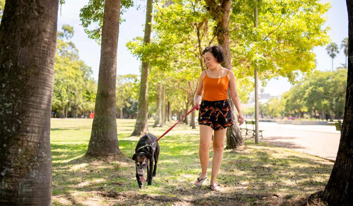 Resident walking with her dog in the park near The Lofts At Wildlight in Yulee, Florida