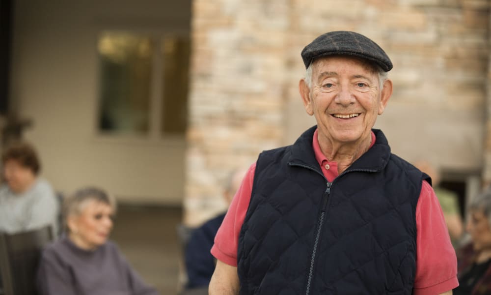 Residents enjoying a social gathering on the patio at Clearwater at The Arboretum in Austin, Texas