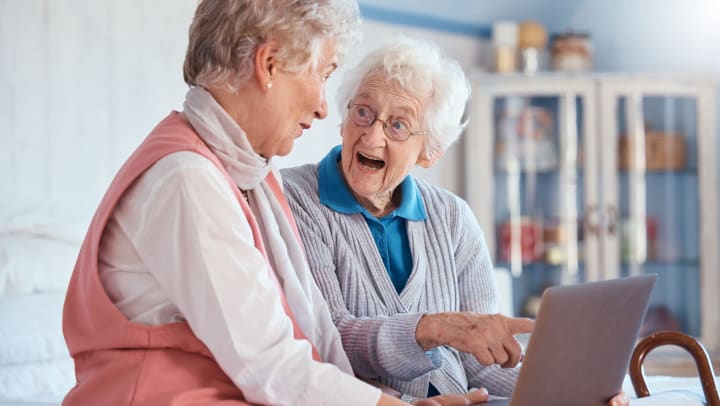Two women with computer discussing senior living panama city