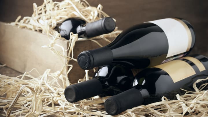 Wine bottles in wooden box and straw