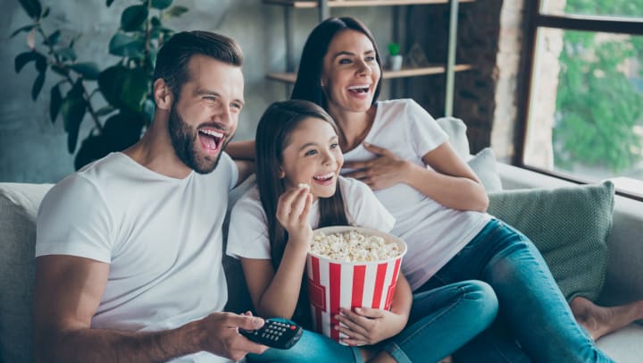 Family enjoying an Oscar- Nominate film  at there home in Olympus Town Center in Keller, Texas. 
