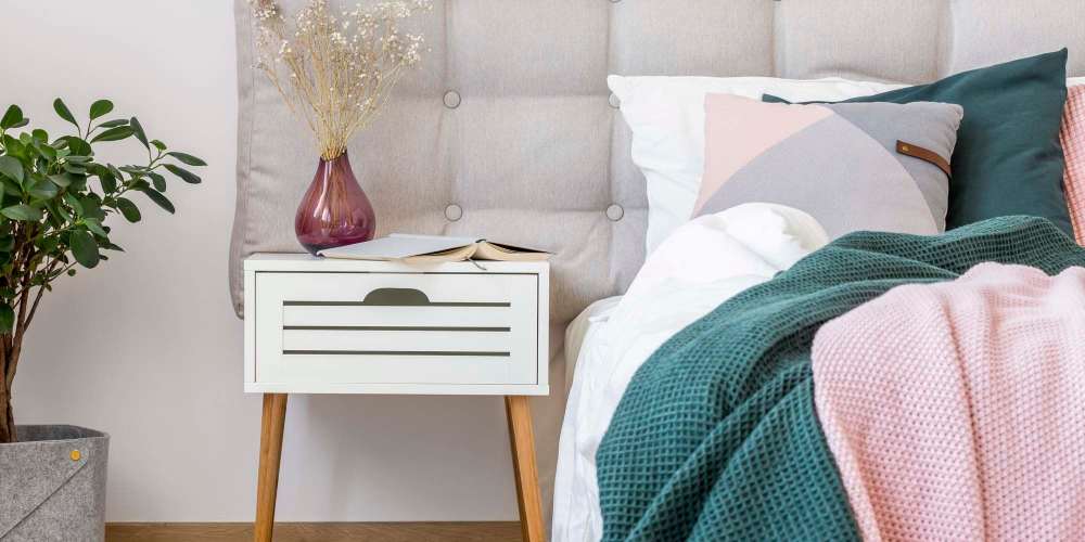 Cozy bedroom with night stand at Cadillac Flats in Napa, California