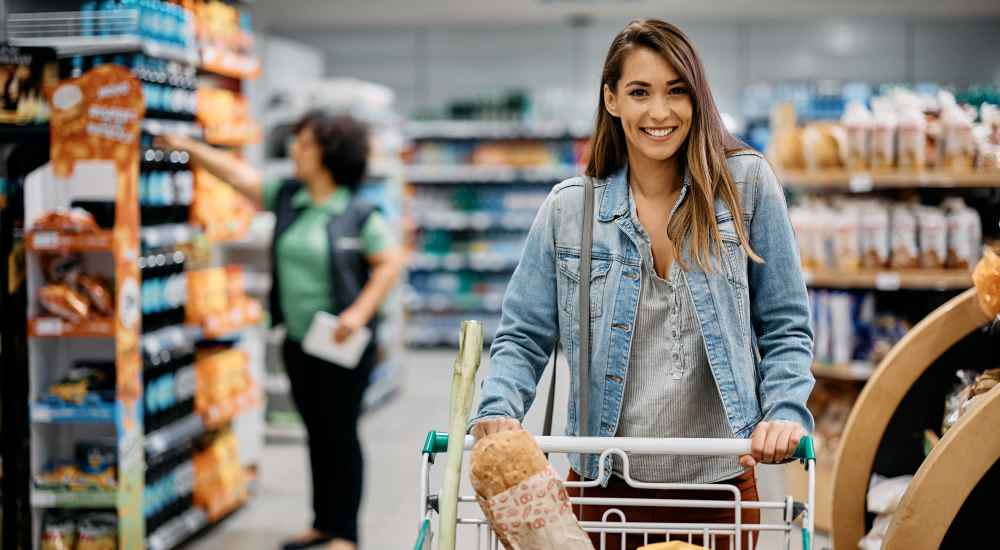 Resident woman with her shopping cart in a supermarket near The Lakes at Statham in Statham, Georgia