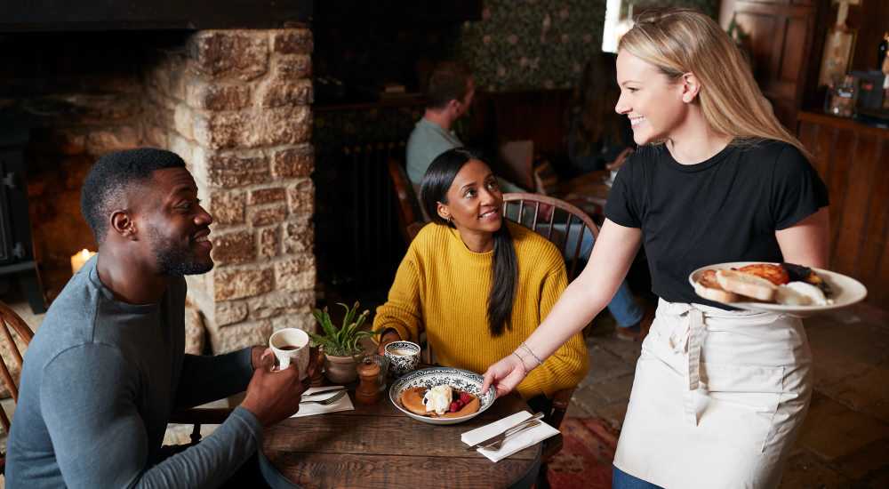 Resident couple having coffee in a cafe near Lila Apartments in Dallas, Texas