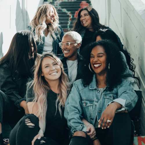 Friends sitting on a staircase near {location_name}} in Las Vegas,