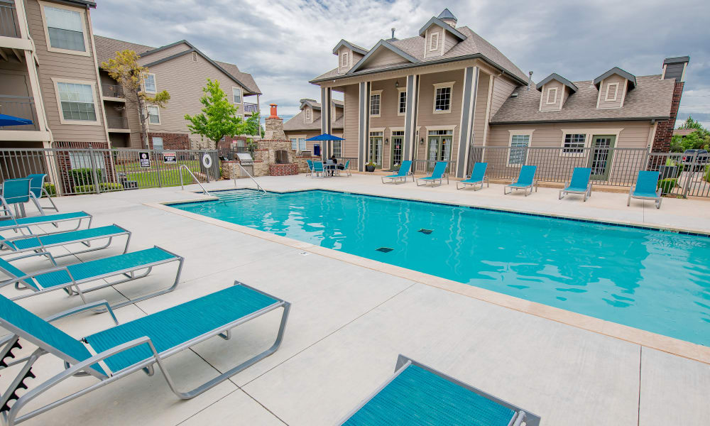 Lounge chairs by the pool at Crown Pointe Apartments in Oklahoma City, Oklahoma