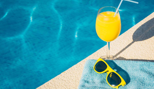 A drink and sunglasses by the pool at Park Trail Apartments in Shelbyville, Tennessee