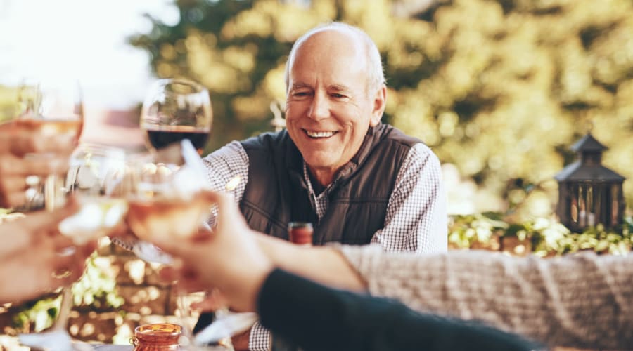 Residents raising a toast to the good life at a wine social at Cascade Park Gardens Memory Care in Tacoma, Washington