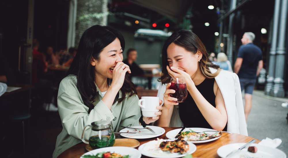 Friends having food at a restaurant near Dawcrest Apartments in Olympia, Washington