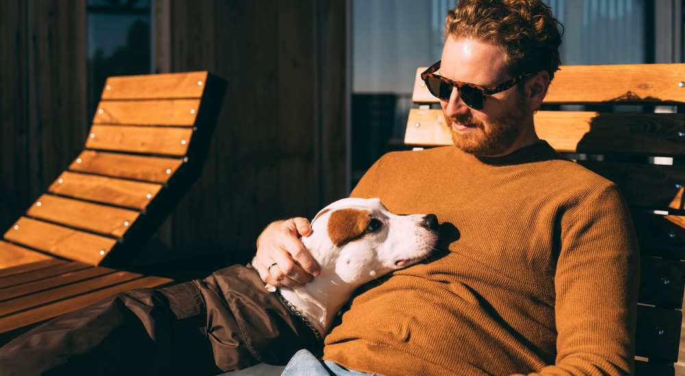 Dog relaxing with resident at Cross Timbers At Grand Street in Amarillo, Texas