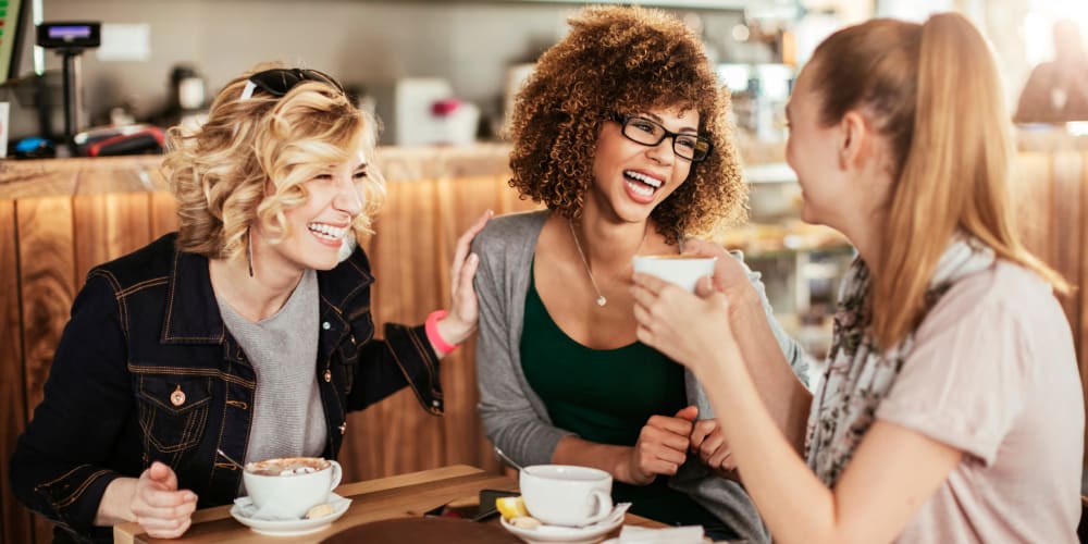 A group of friends drinking coffee near Vesta Creeks Run in North Charleston, South Carolina