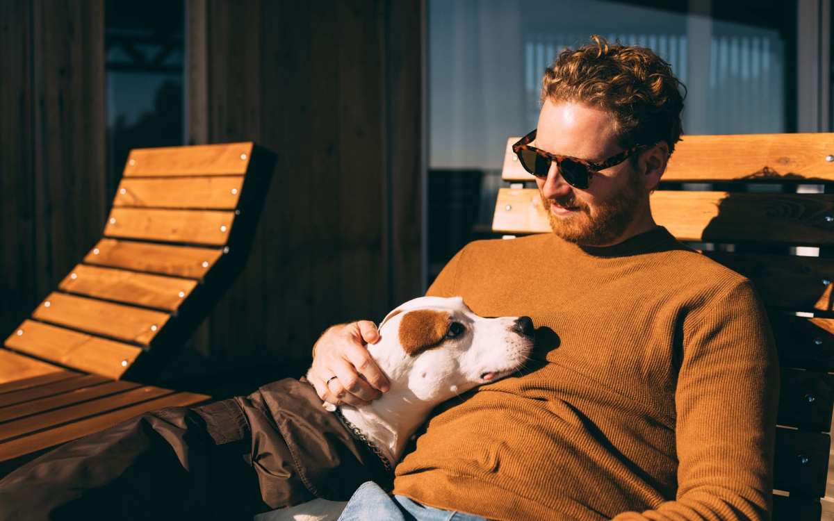 Resident petting his dog in their pet-friendly home at Fair Oaks Apartments in Sacramento, California