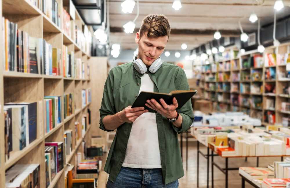 Resident reading book in university library near Natomas Park Apartments in Sacramento, California