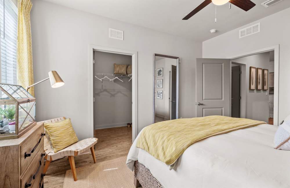 Modern bedroom with bed, ceiling fan and window at Pier Park Crossings in Panama City Beach, Florida