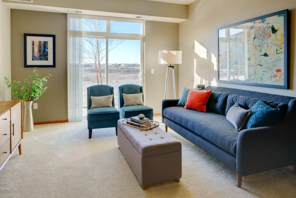 Beautiful living room with lots of natural lighting at Remington Cove Apartments in Apple Valley, Minnesota