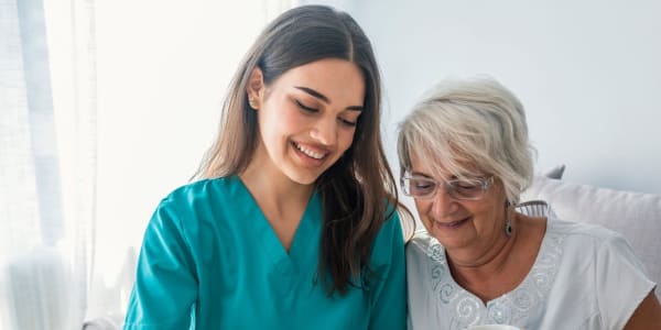 Resident reading with caregiver at Montello Care Center in Montello, Wisconsin