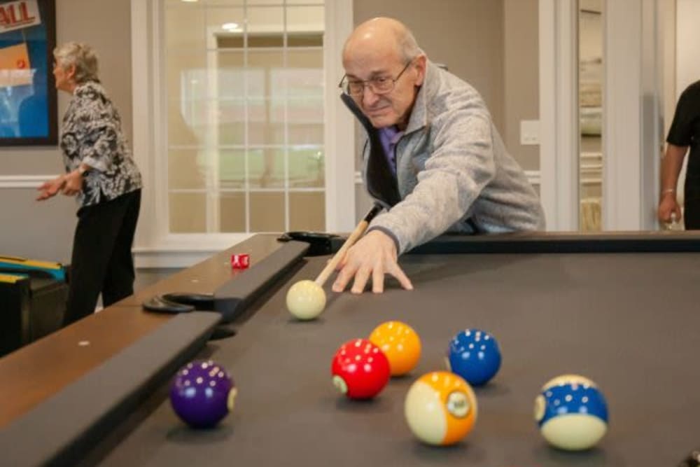 A resident playing a game of pool at Crescent Fields at Huntingdon Valley in Huntingdon Valley, Pennsylvania