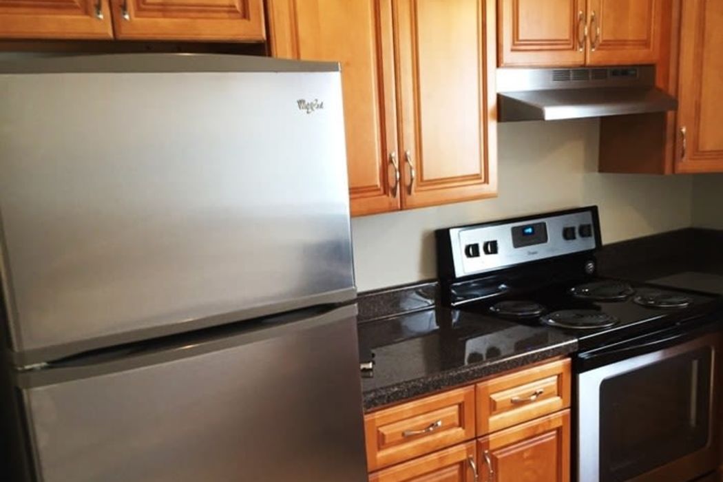 Stainless-steel refrigerator and cooking range at Orchard Hills Apartments in Whitehall, Pennsylvania