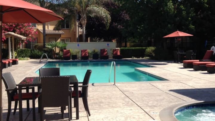 Swimming pool with patio furniture. 