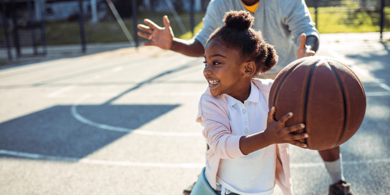 A child playing basketball at a school near San Mateo Point in San Clemente, California