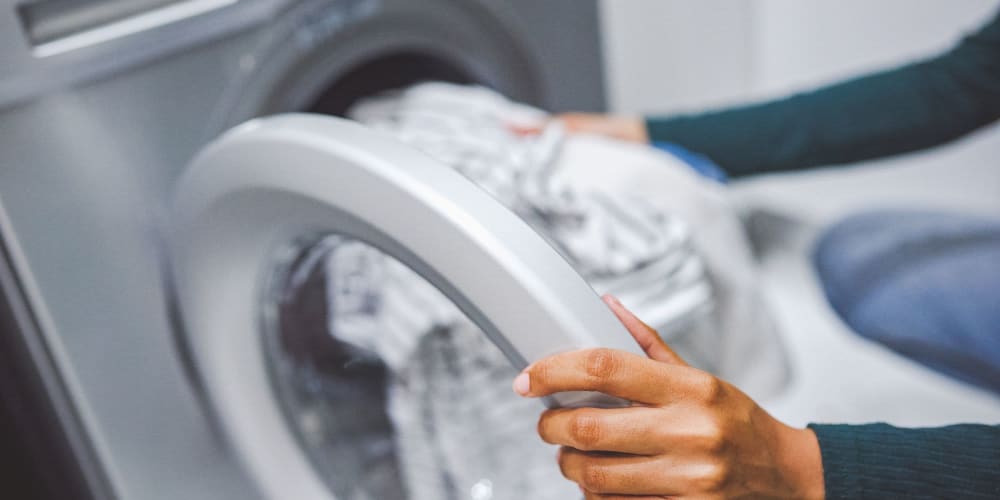 Resident doing laundry in their apartment Bella Rose in Antioch, California