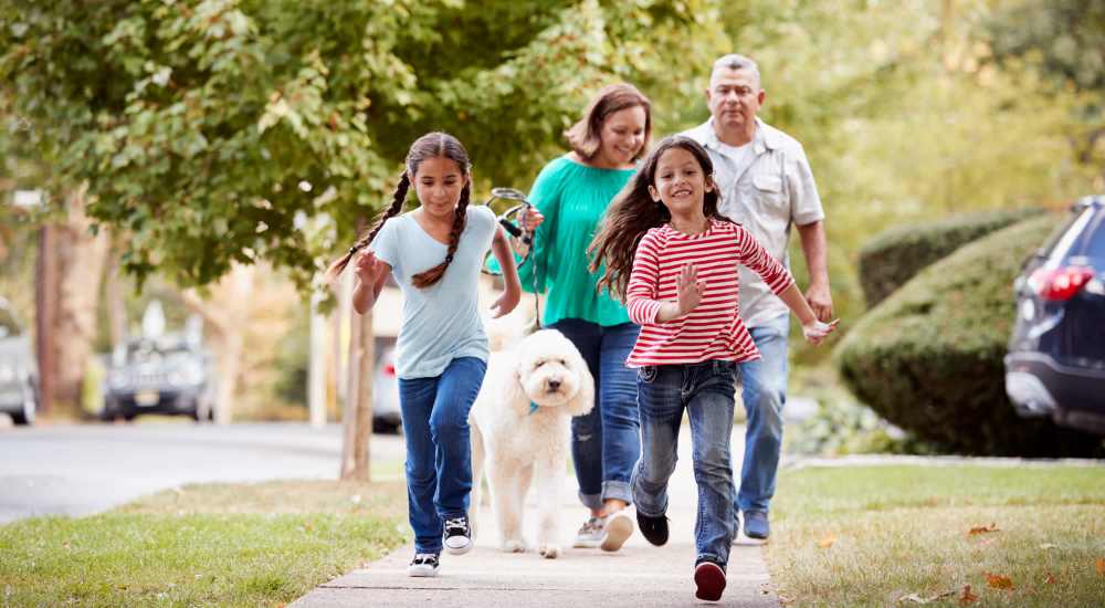 Family walking with dog near The Reid in Tucker, Georgia 
