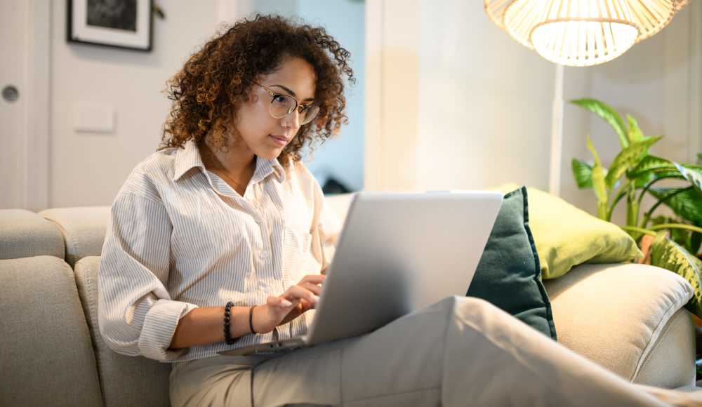 Resident at home working on laptop at Belcrest Plaza in Hyattsville, Maryland
